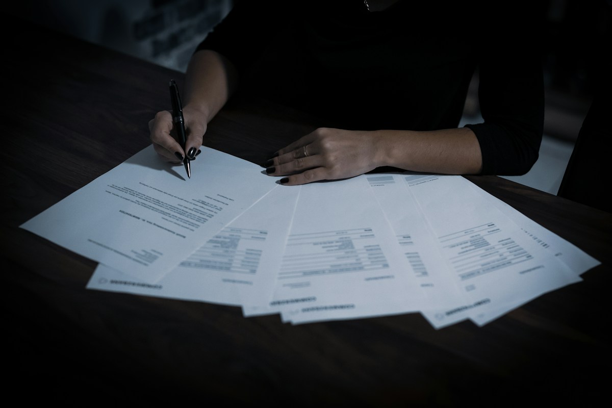 Papers spread across a table while someone reads through them